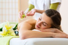 Applying Oil To a Woman On a Massage Table
